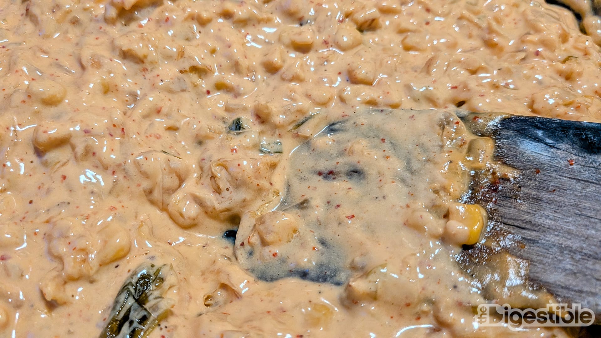 Close up shot of melty kimchi corn queso dip.