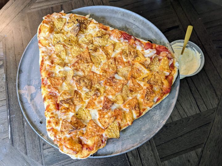 Nacho cheese Doritos on pizza.