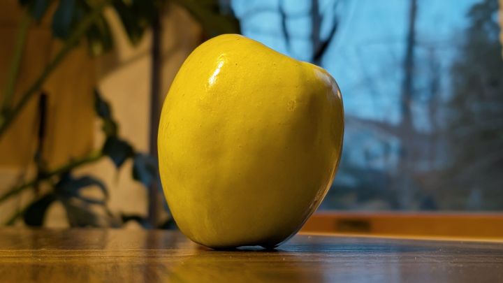 Yellow-green apple on a table.
