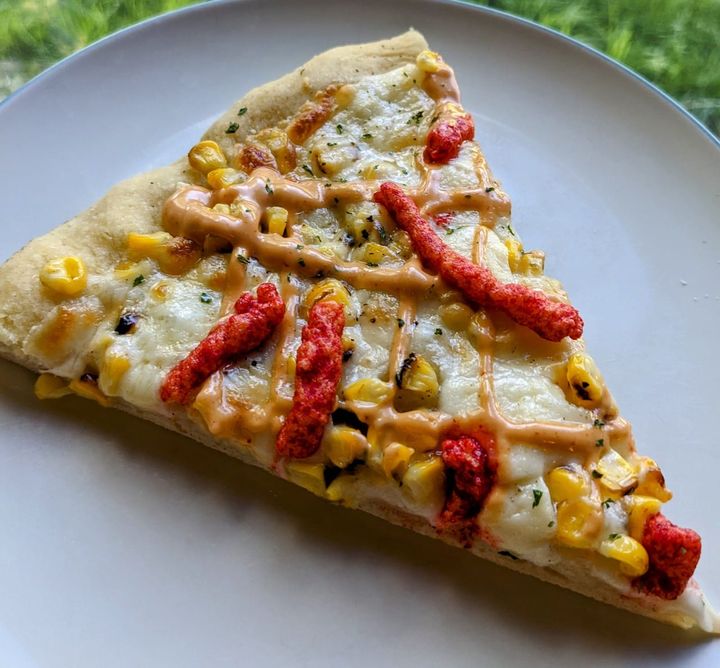 Corn and cheetos on pizza.