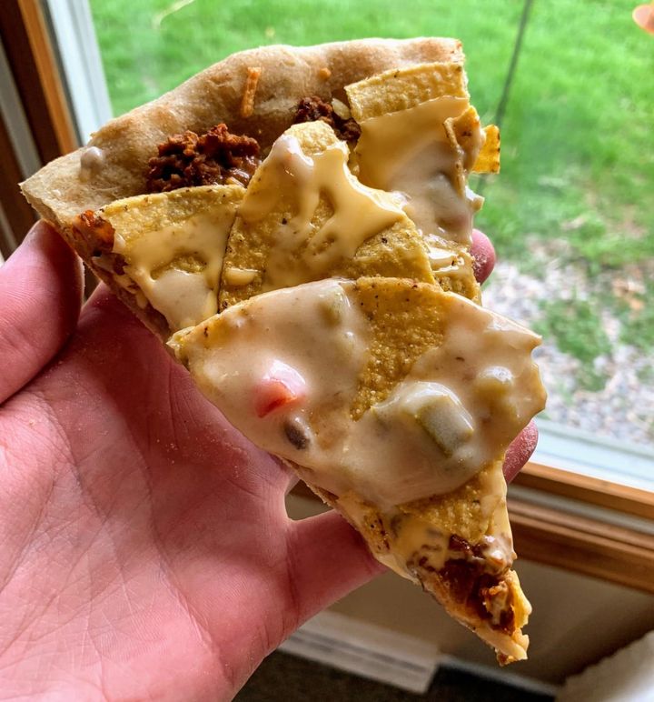 Chips and nacho cheese on pizza.