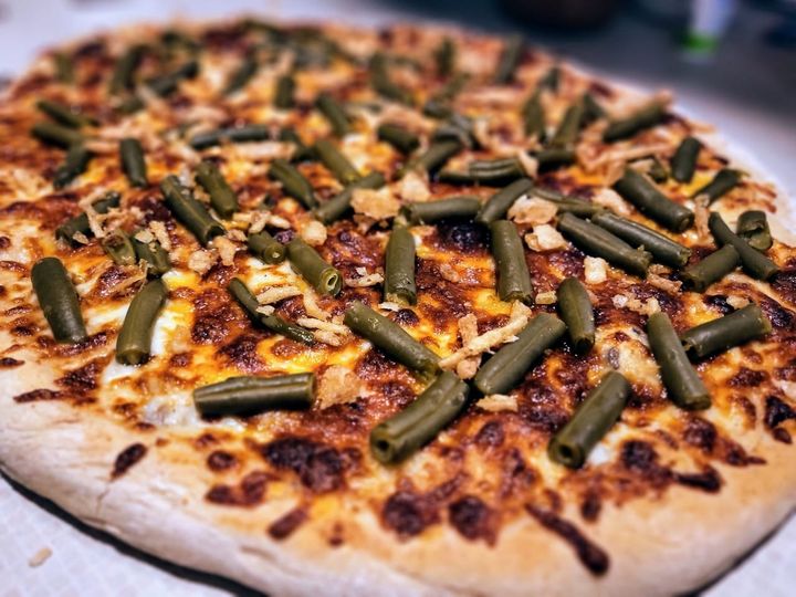 Green beans and fried onions on pizza.