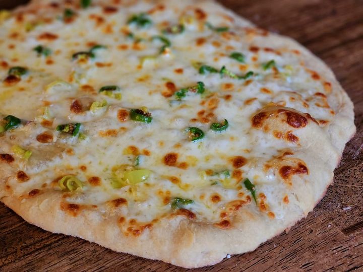 Jalepenos and banana peppers on pizza.