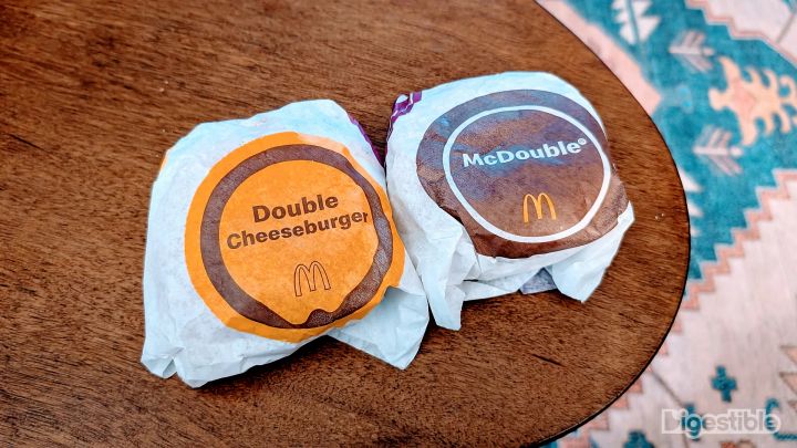 A McDonald's Double Cheeseburger and McDouble on a table.