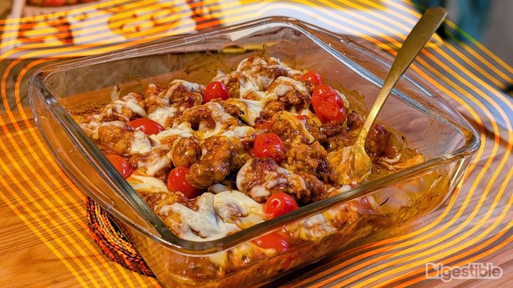 Orange chicken parm in a glass casserole dish.