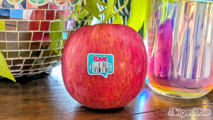 A Rave apple on a counter with a disco ball in the background.