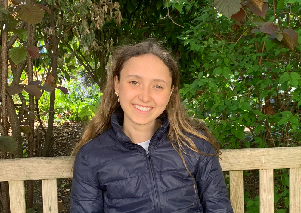 Photograph of Nicole Toft, sitting on a park bench