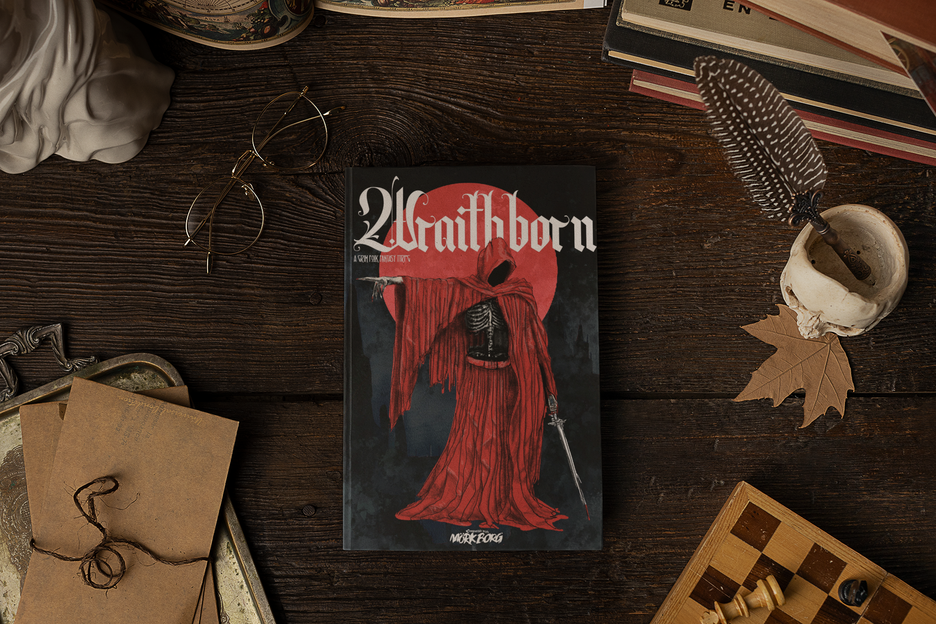 A hardcover book showing WraithBorn and a red cloaked figure sits surrounded by trinkets