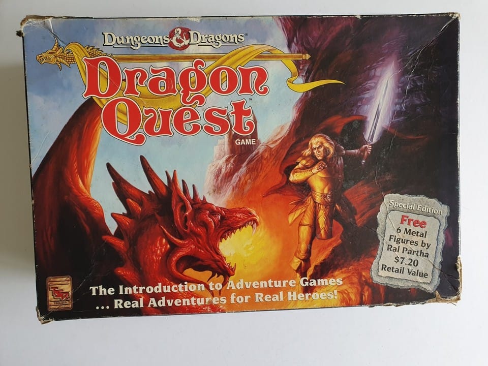 A photo of the Dragon Quest box. Text reads "The Introduction to Adventue Games...Real Adventures for Real Heroes! There is also a text box that reads "Special Edition Free 6 Metal Figures by Ral Partha $7.20 Retail Value"