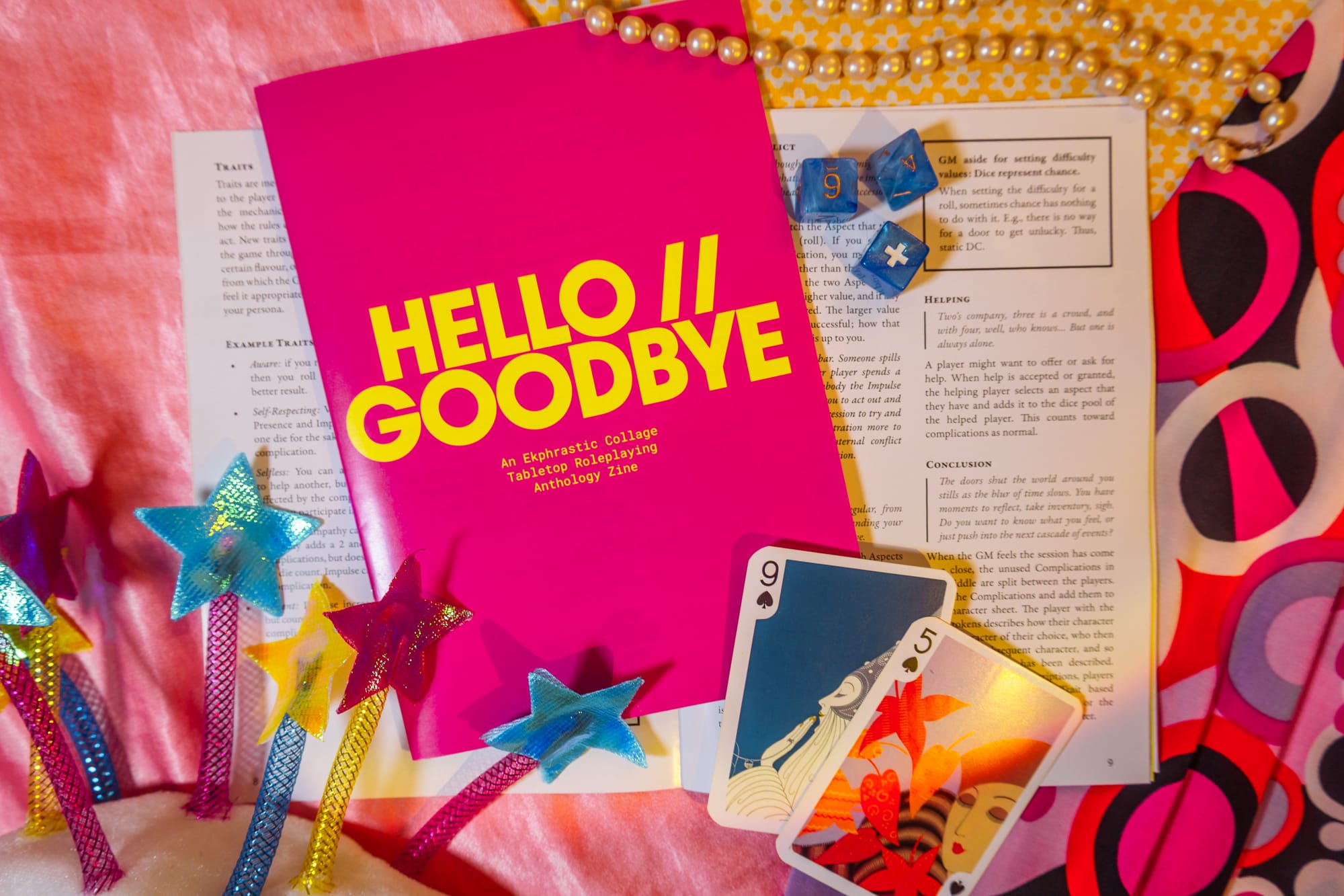 A pink a5 zine lies on a collage background, a page open to reveal a game