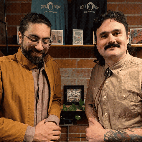 GIF of Jordan and Paul posing in front of the camera at The Rook Room