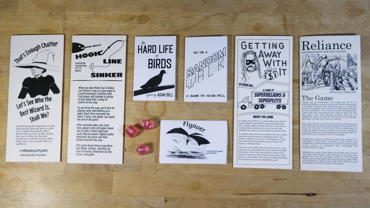 8 black and white zines arranged in a grid with dice.