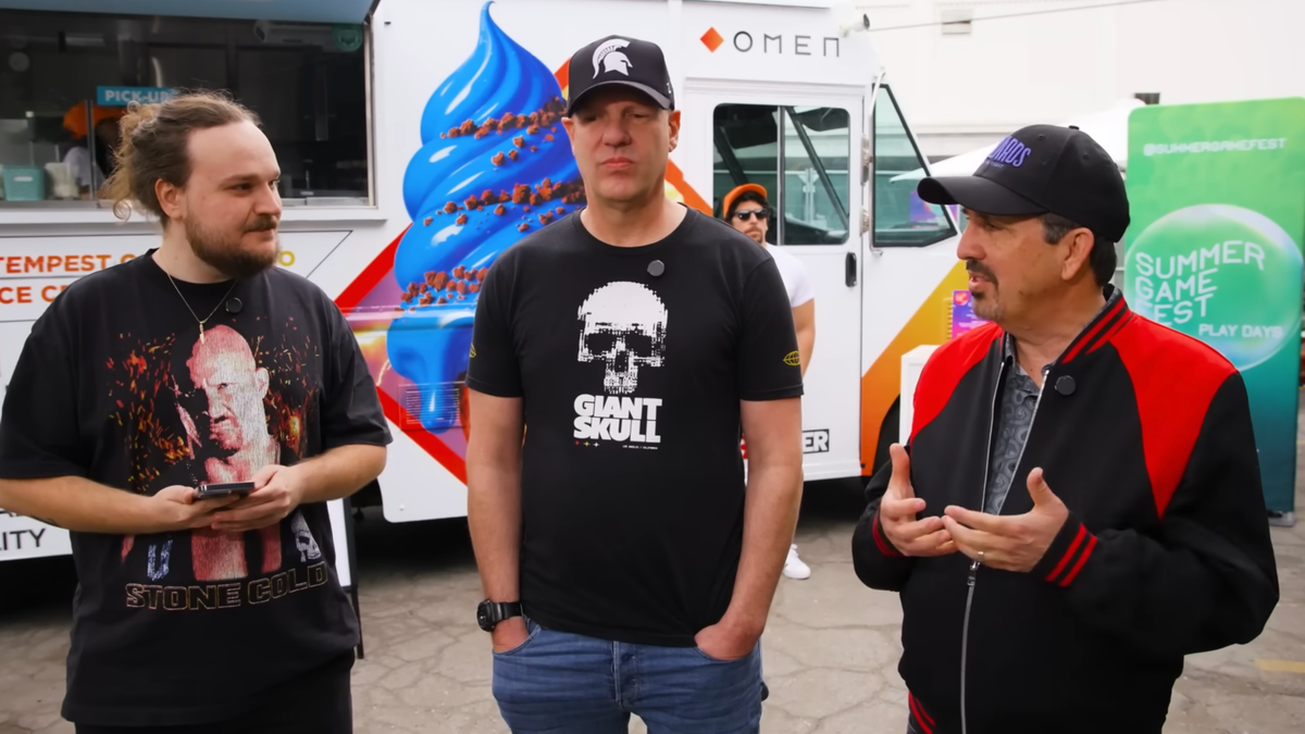 Left to right, Spaceboy, Stig Asmussen, and John Hight stand in front of a white ice cream truck. All are wearing casual clothes, while Stig and John wear black ballcaps with company logos.