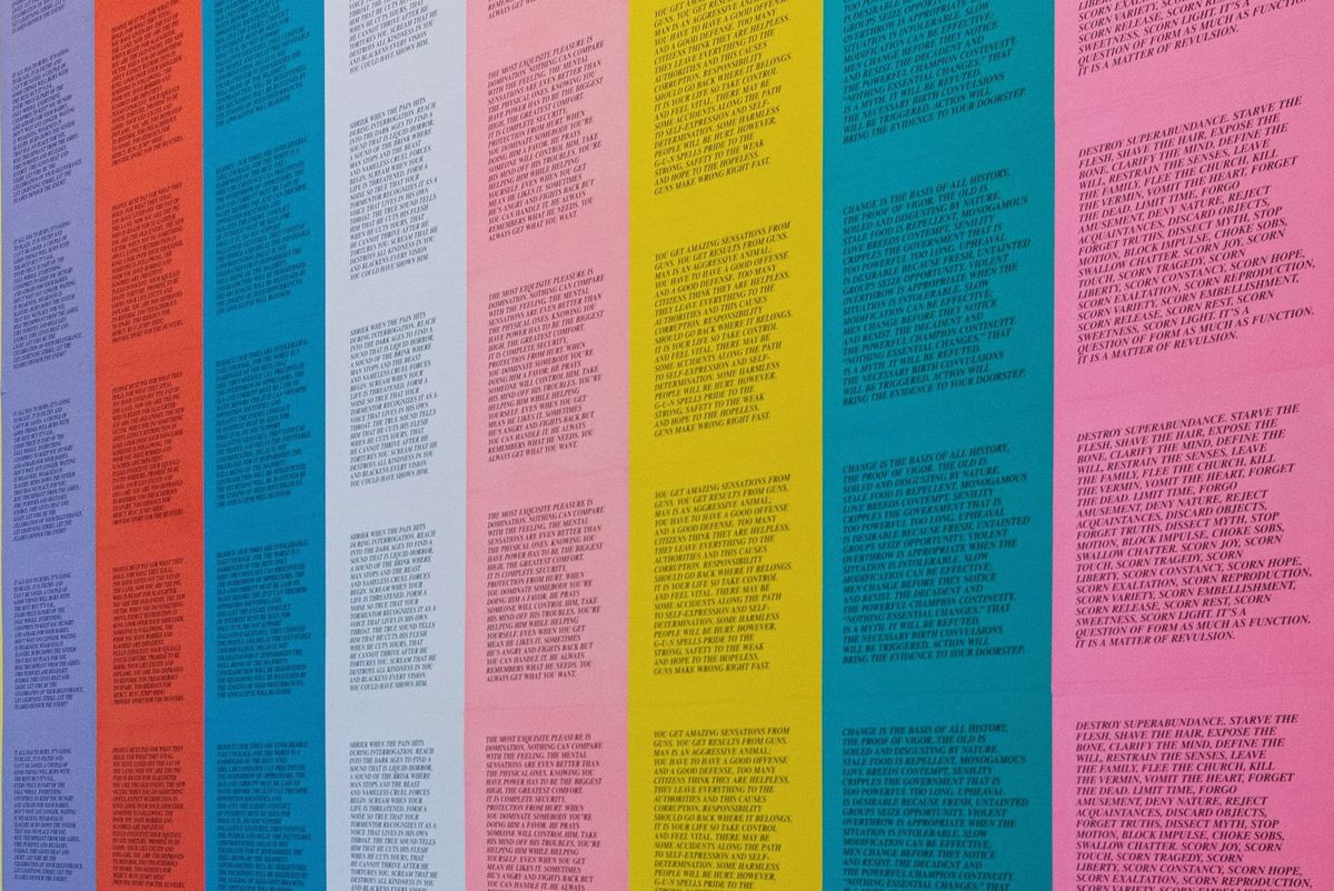 a colorful panel of repeating quotes stuck on a wall