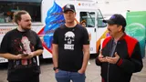 Left to right, Spaceboy, Stig Asmussen, and John Hight stand in front of a white ice cream truck. All are wearing casual clothes, while Stig and John wear black ballcaps with company logos.