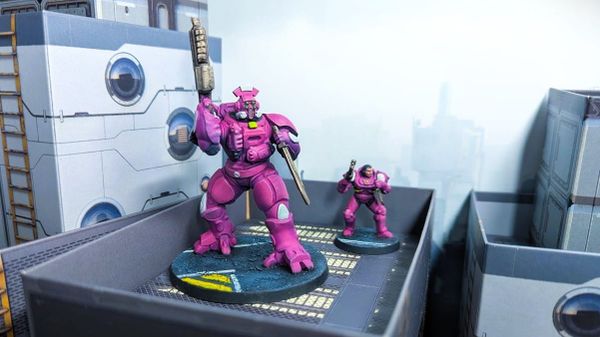 Two Zeo Genesis minis, a mech and a human, painted bright pink and posed in a futuristic city.