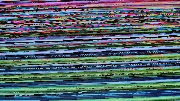 multicolor static from an old CRTV, reds fading into blues and greens