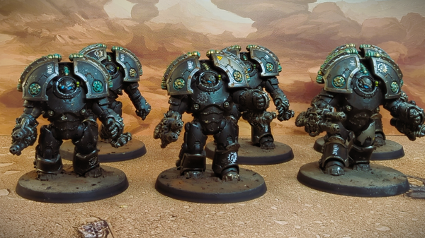 A photo of six Iron Hands Saturnine Terminators. They're posed against a deser backdrop.
