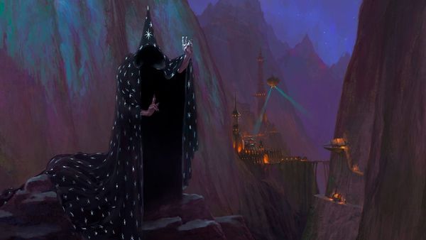 A black robed wizard, embroided with stars, stands on top of a stone peak. 