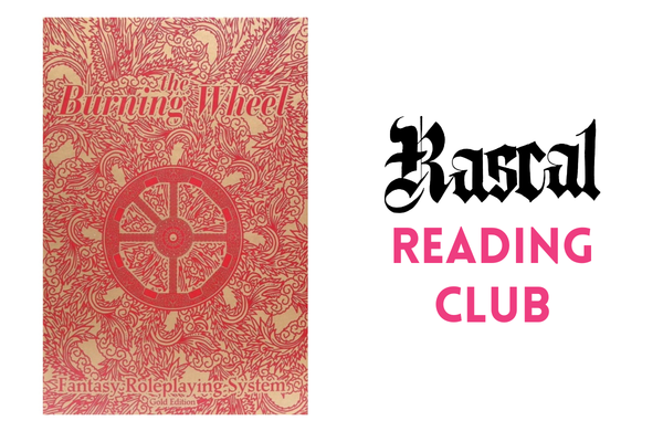 the cover of Burning Wheel RPG which is red and gold with a wheel in the centre