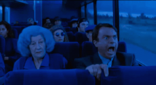 GIF of Sam Neill on a bus screaming. Everything is blue.