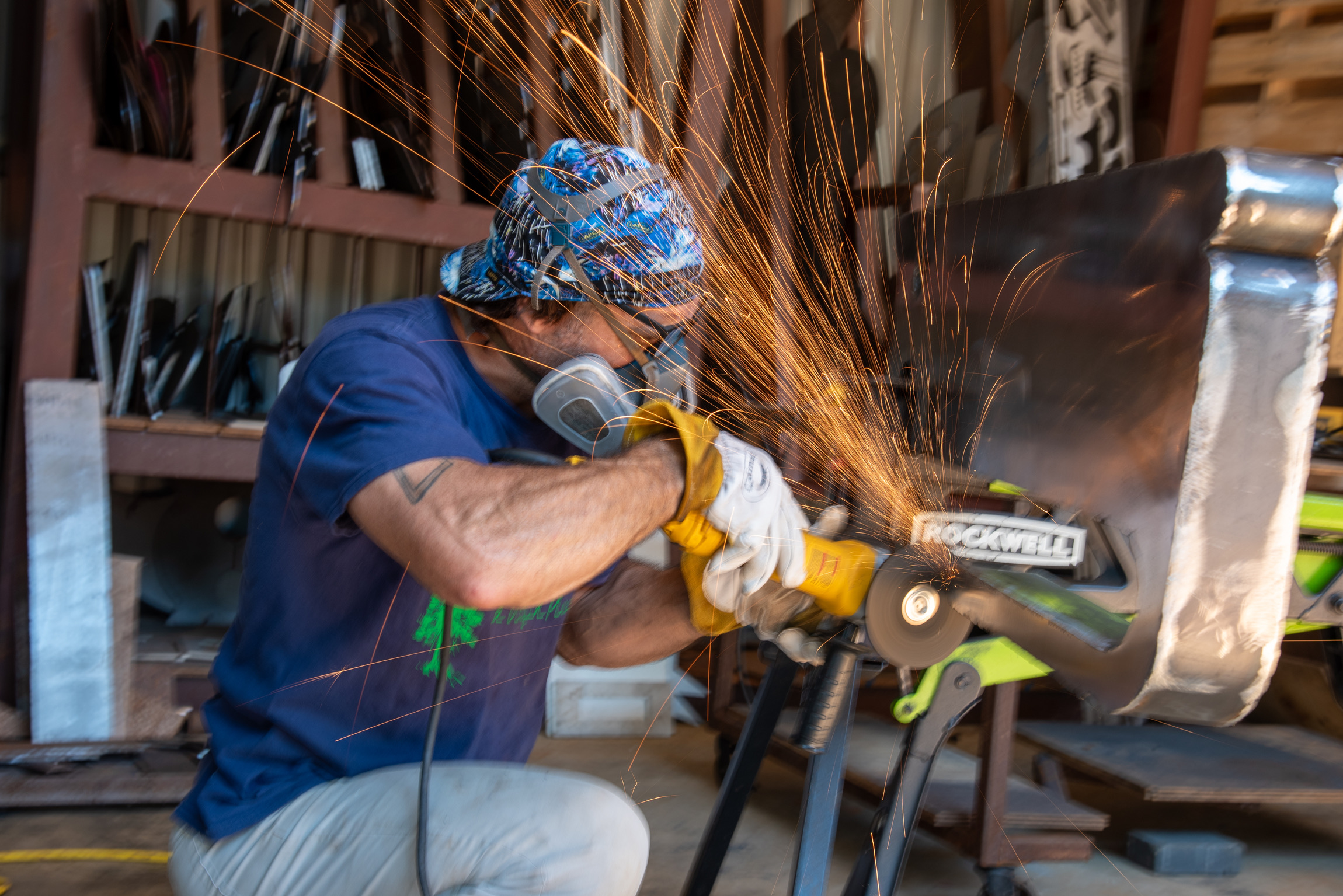 Man welding a metal sculpture.