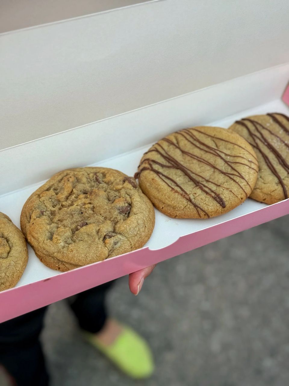 close-up of hands holding a cookie and coffee, cozy and soft light, self-care and simple pleasures