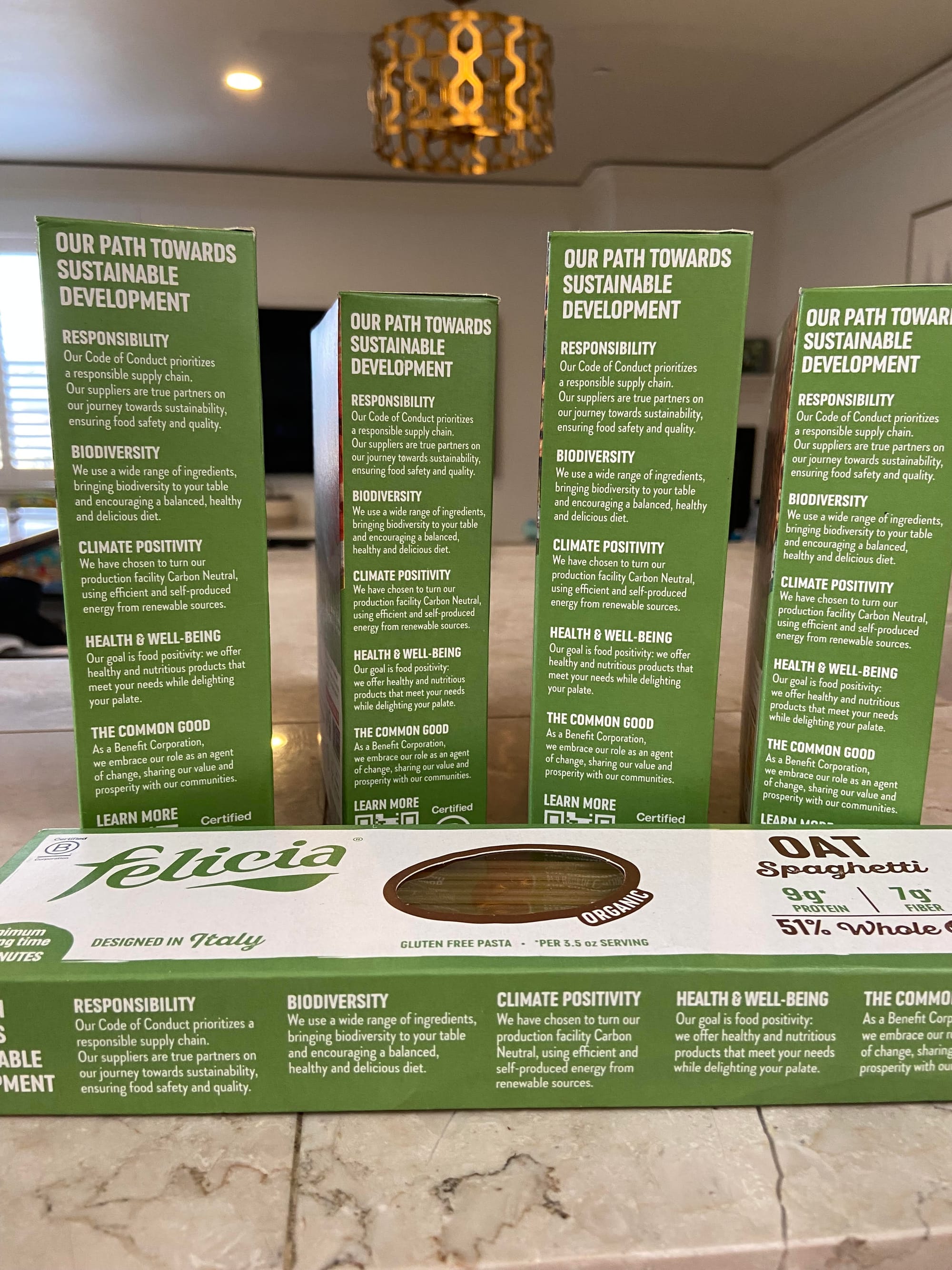 Boxes of Felicia pasta with the sides explaining some of its sustainable development initiatives