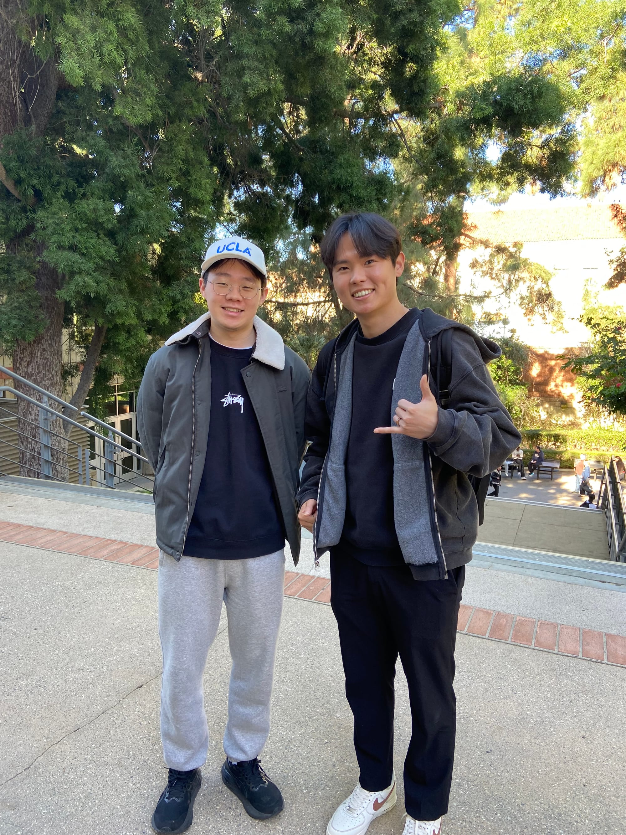 Two students smiling for photo outside on college campus