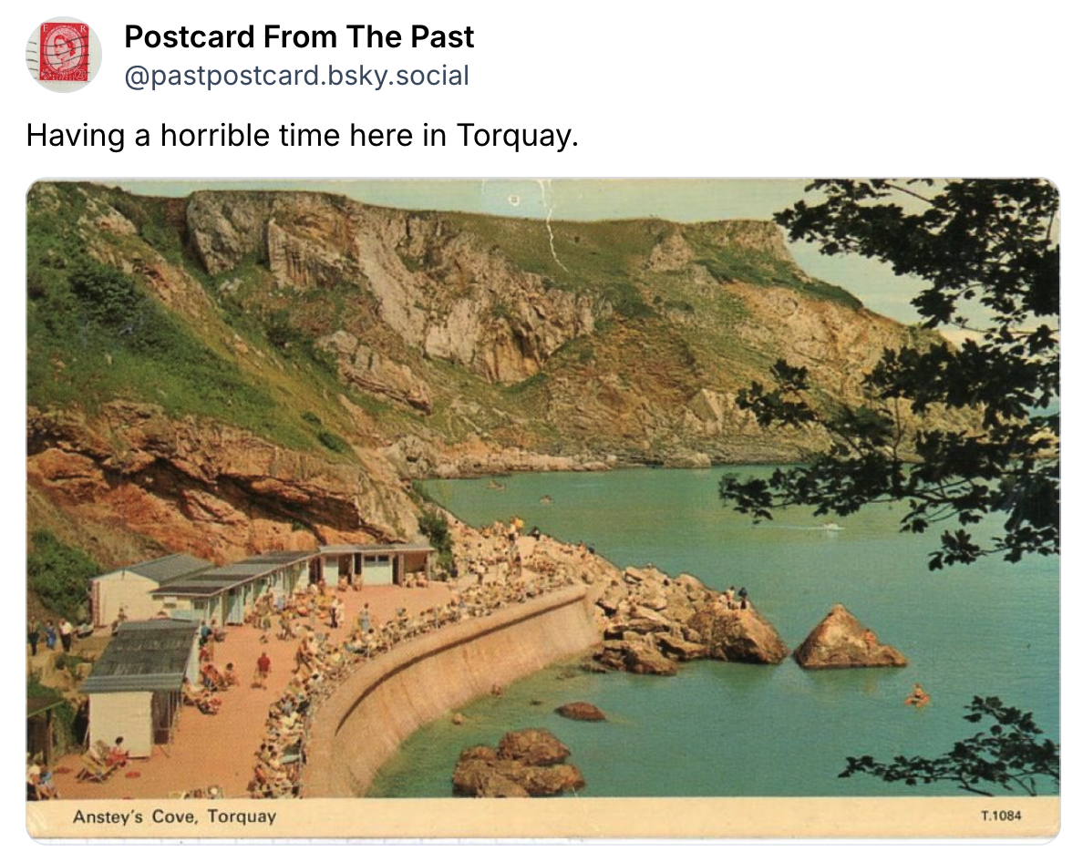 This is a screencapture of a post on Bluesky. The post is from the account "Postcard from the past" and it's an image of a postcard. On the back someone has written: "Having a horrible time here in Torquay."