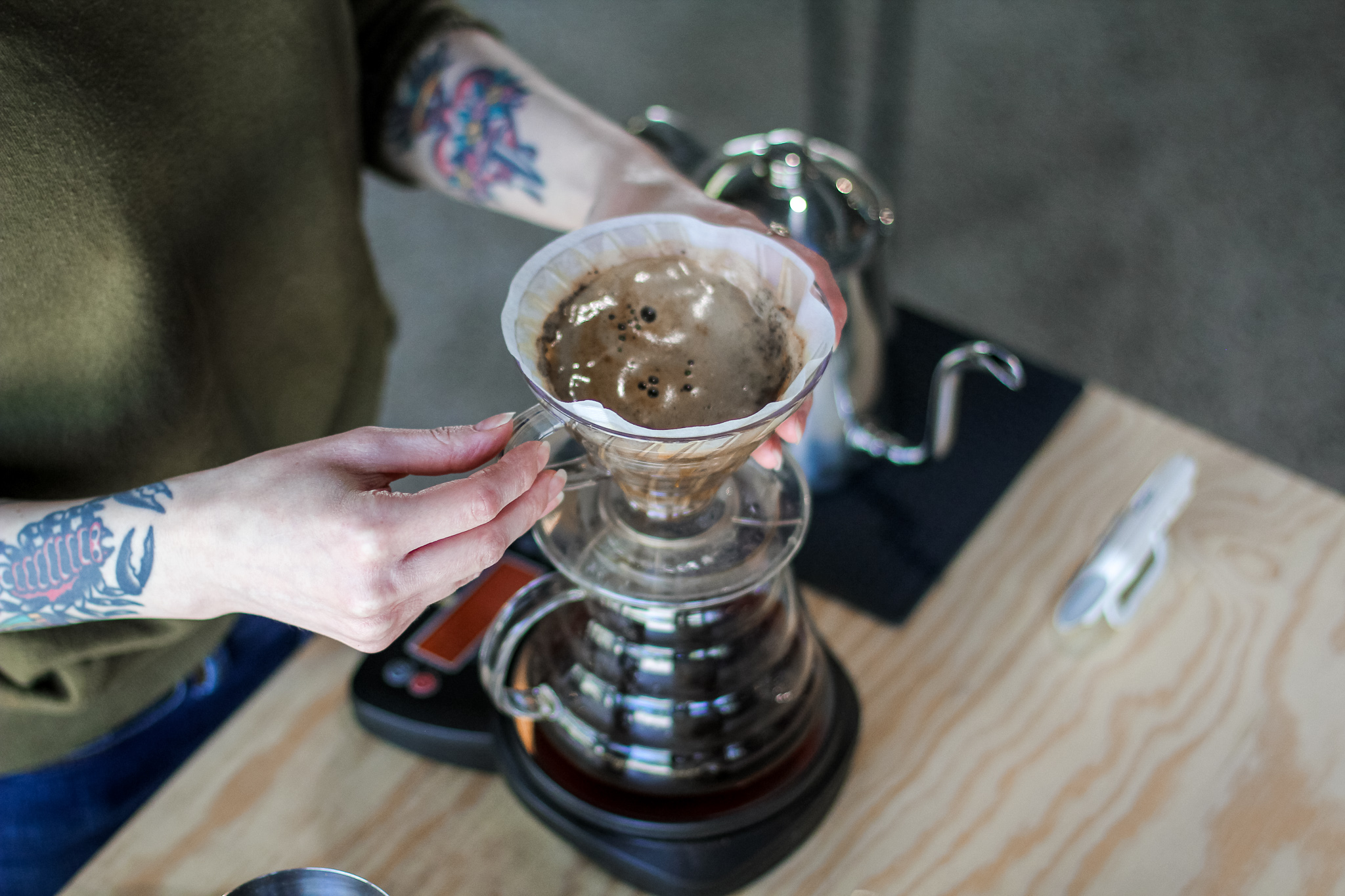 Pouring hot water over coffee grounds for V60 bloom