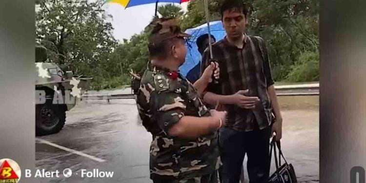 A cropped scene from a video showing MP Ramanathan Archchuna being rescued by Sri Lankan military personnel during the floods.