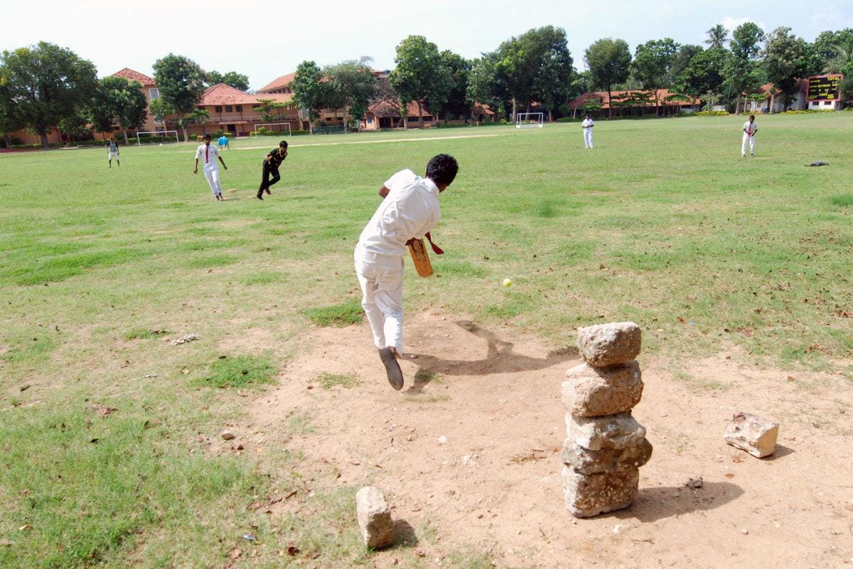 Young children playing cricket on the St. John’s College ground in Jaffna. Photo courtesy: ESPNcricinfo / The Cricket Monthly.