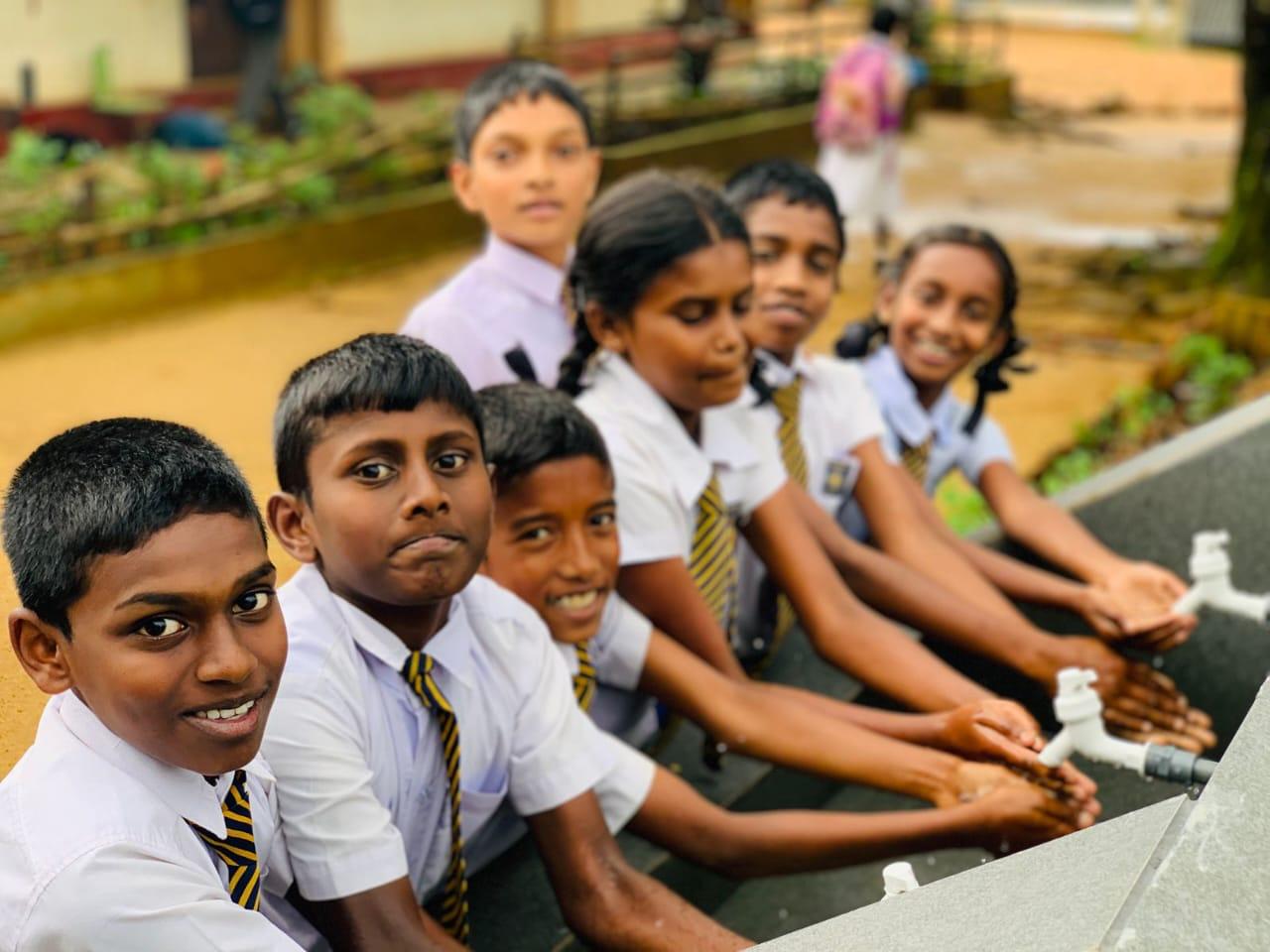 Children use a water facility installed through an IMHO school project in Sri Lanka’s upcountry region.