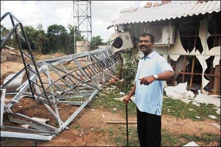 S. P. Thamilselvan, the LTTE’s political head, in front of the Voice of Tigers (VOT) office after it was destroyed in an aerial bombing by the Sri Lankan military.