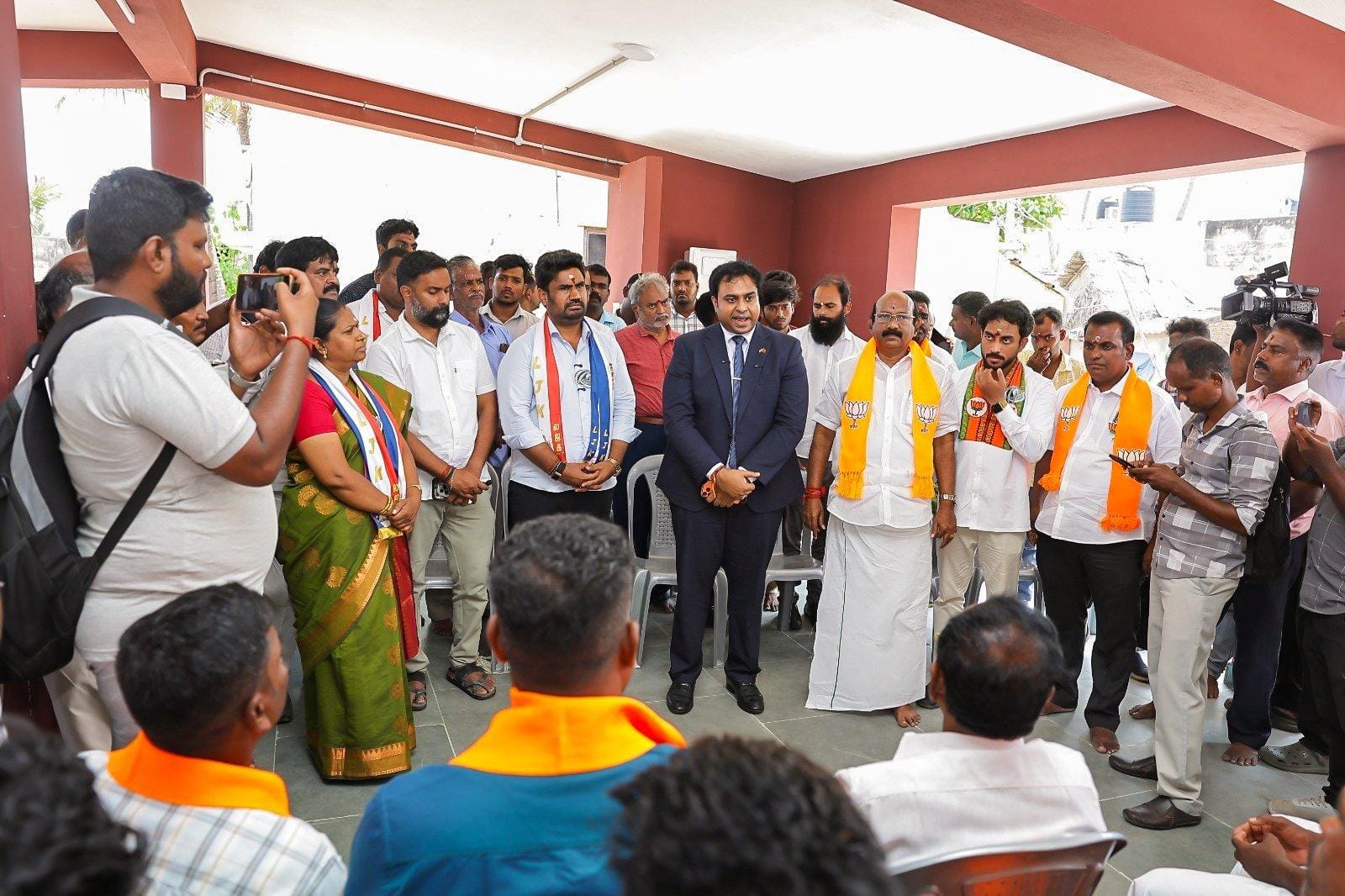 Ganesanathan Ketheeswaran, Sri Lanka’s Deputy Consul General for South India,wearing a coat and tie, speaks with fishermen in Puducherry at a gathering that has sparked political controversy.