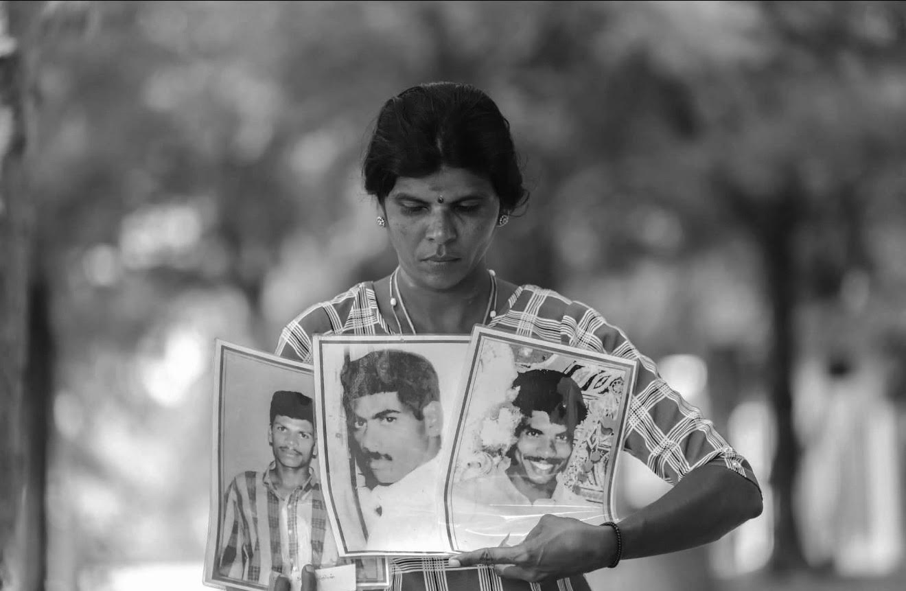 Sasikumar Ranjinithevi carries portraits of three missing family members