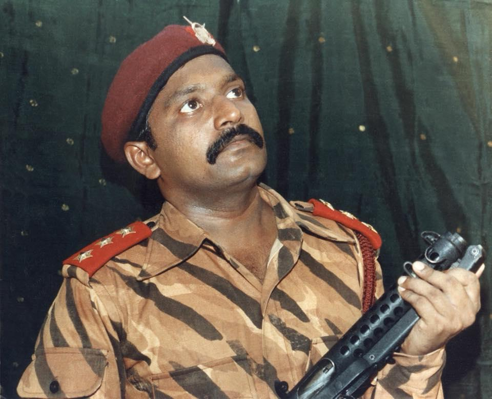 The cover of the LTTE's 1984 wall calendar, featuring Prabhakaran holding a firearm. The calendar was part of the organization's early effort to build Prabhakaran's public image in Tamil Nadu.