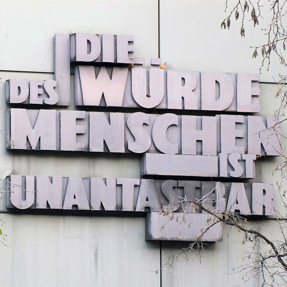 The words “Die Würde des Menschen ist unantastbar” mounted on the exterior wall of the Regional Court in Braunschweig.
