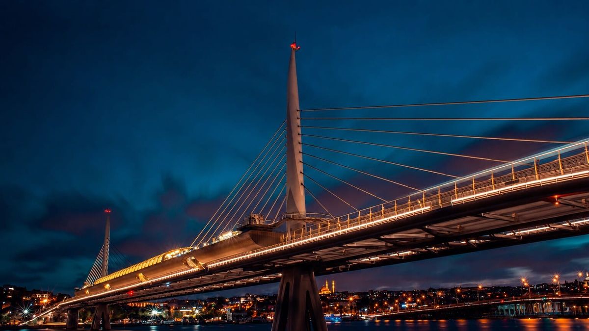 A bridge carrying transport links through a European landscape at dusk, symbolising the interconnected systems on which societal resilience depends.