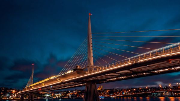 A bridge carrying transport links through a European landscape at dusk, symbolising the interconnected systems on which societal resilience depends.