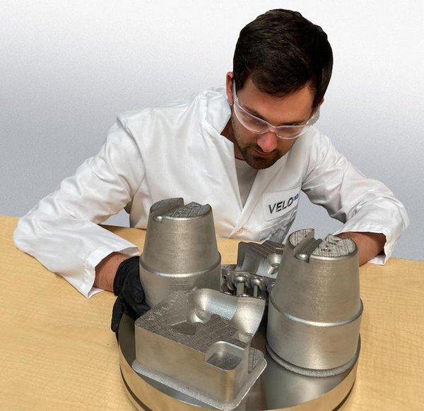 Engineer evaluating a M300 tool steel print of conformal cooled tooling and high pressure die casting inserts.