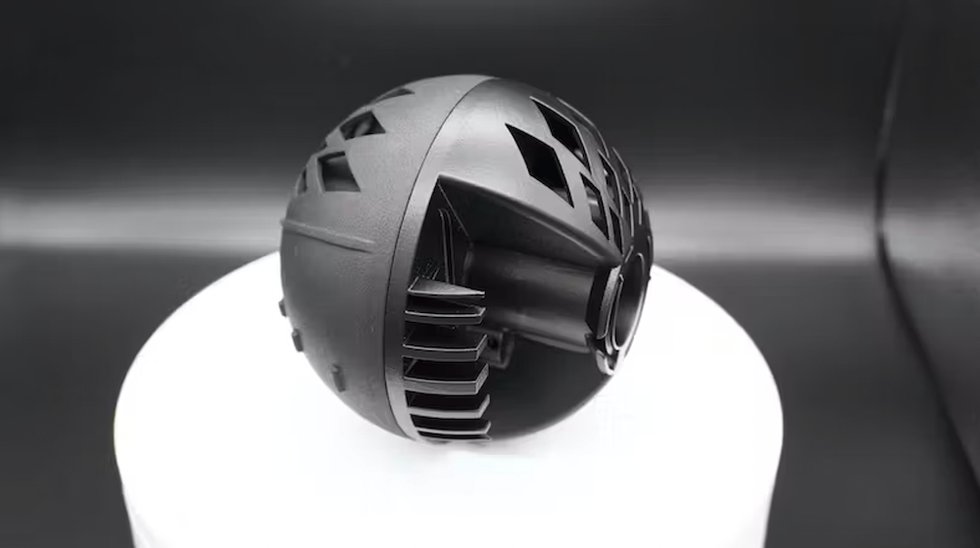 HP MJF 3D printed parts assembled into a sphere. Both are dyed black with one hemisphere vapour smoothed (right) and the other with a standard finish (left)