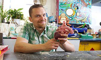 Richard Arm with a cast of a human heart - ntu.ac.uk