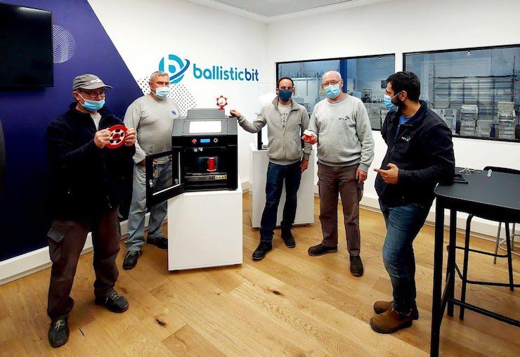 Ballistic Bit PostProcess      In their Israel office, Ballistic Bit employees display finished parts from their in-house printers.