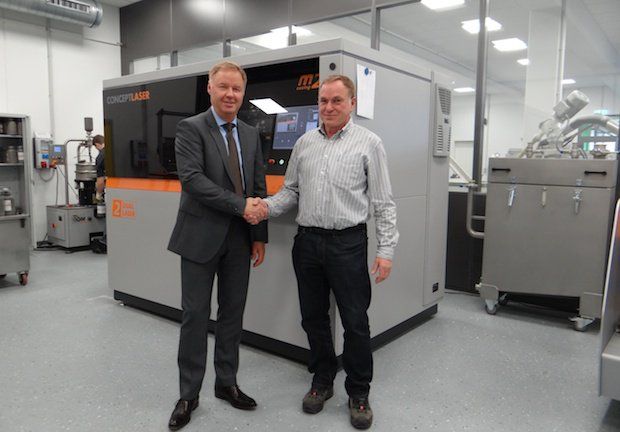 Harald Henkel, FKM Sintertechnik GmbH, and Oliver Edelmann, Concept Laser GmbH, with newly installed M2 cusing Multilaser.