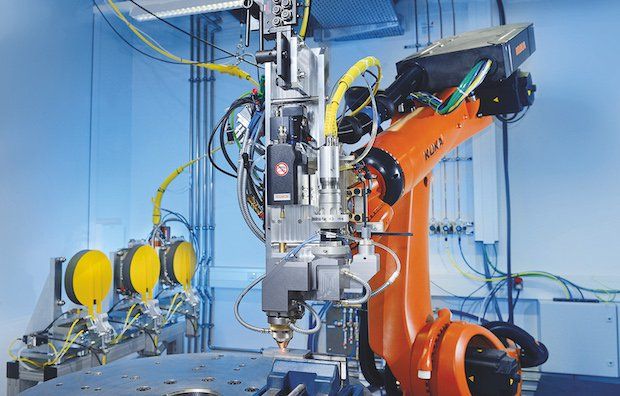 Robot research cell with automatic processing head changing system during wire laser material deposition at Fraunhofer ILT. (Credit: Fraunhofer ILT, Aachen, Germany)