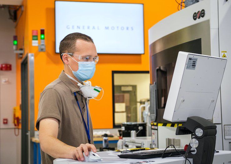 GM 3DP facility      General Motors Manufacturing Engineer Benjamin LeBlanc inspects a 3D printer at the General Motors Additive Industrialization Center at the GM Tech Center in Warren, M...