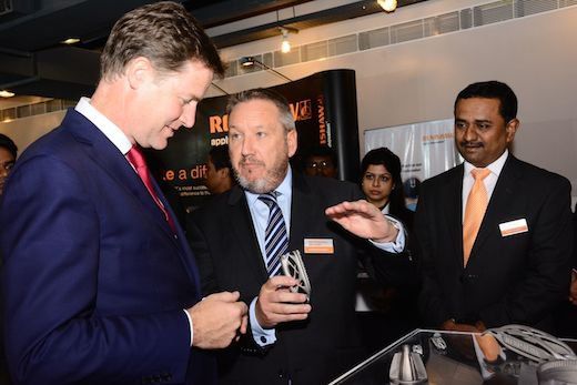 Renishaw's Rhydian Pountney (centre) explains the additive manufacturing process to Nick Clegg.