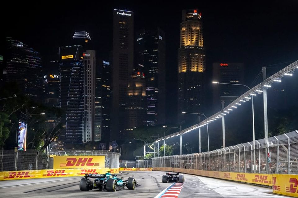 Shot of F1 Cars in Singapore at night time amongst the city lights